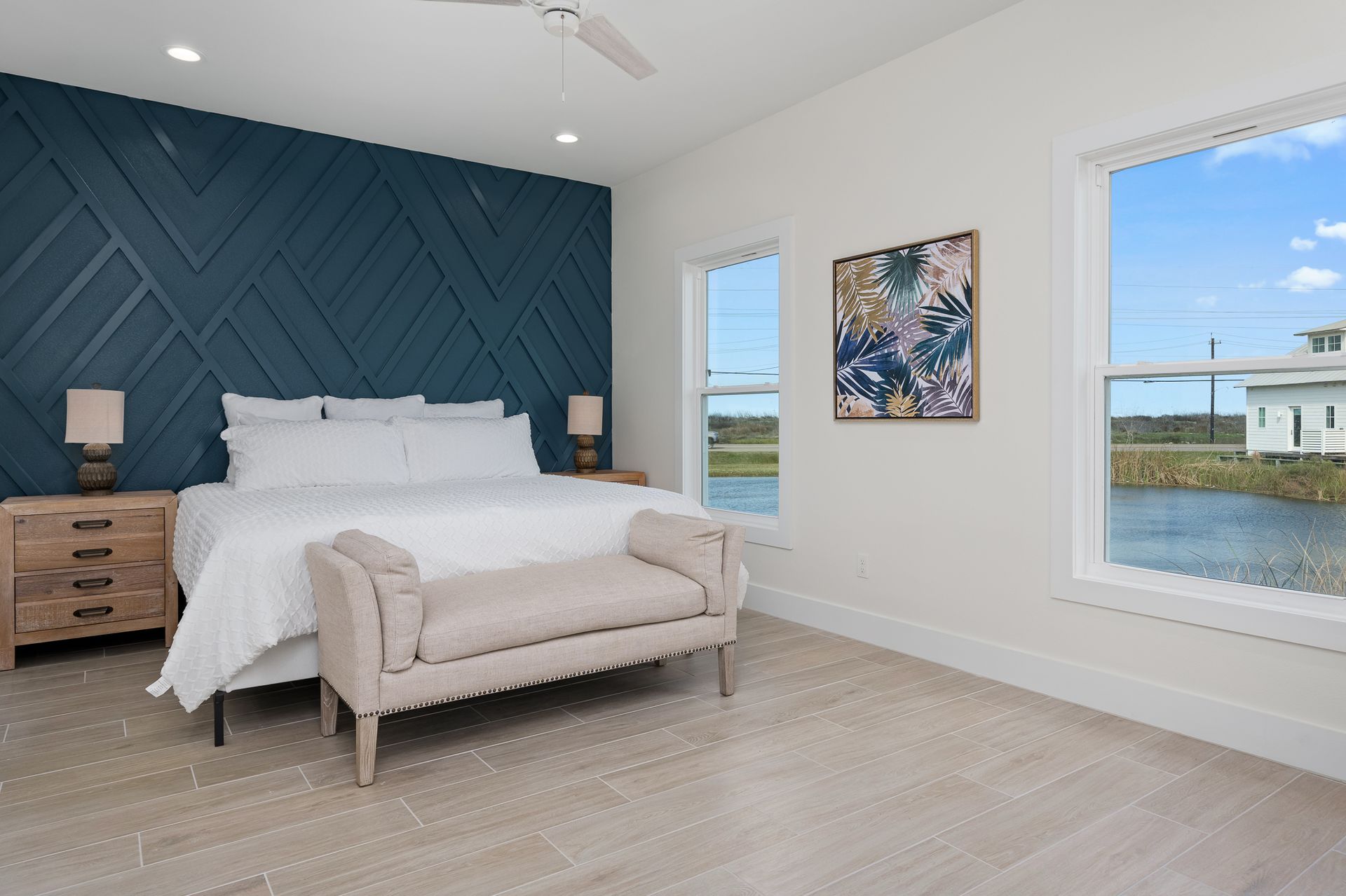 A bedroom with a large bed and a bench