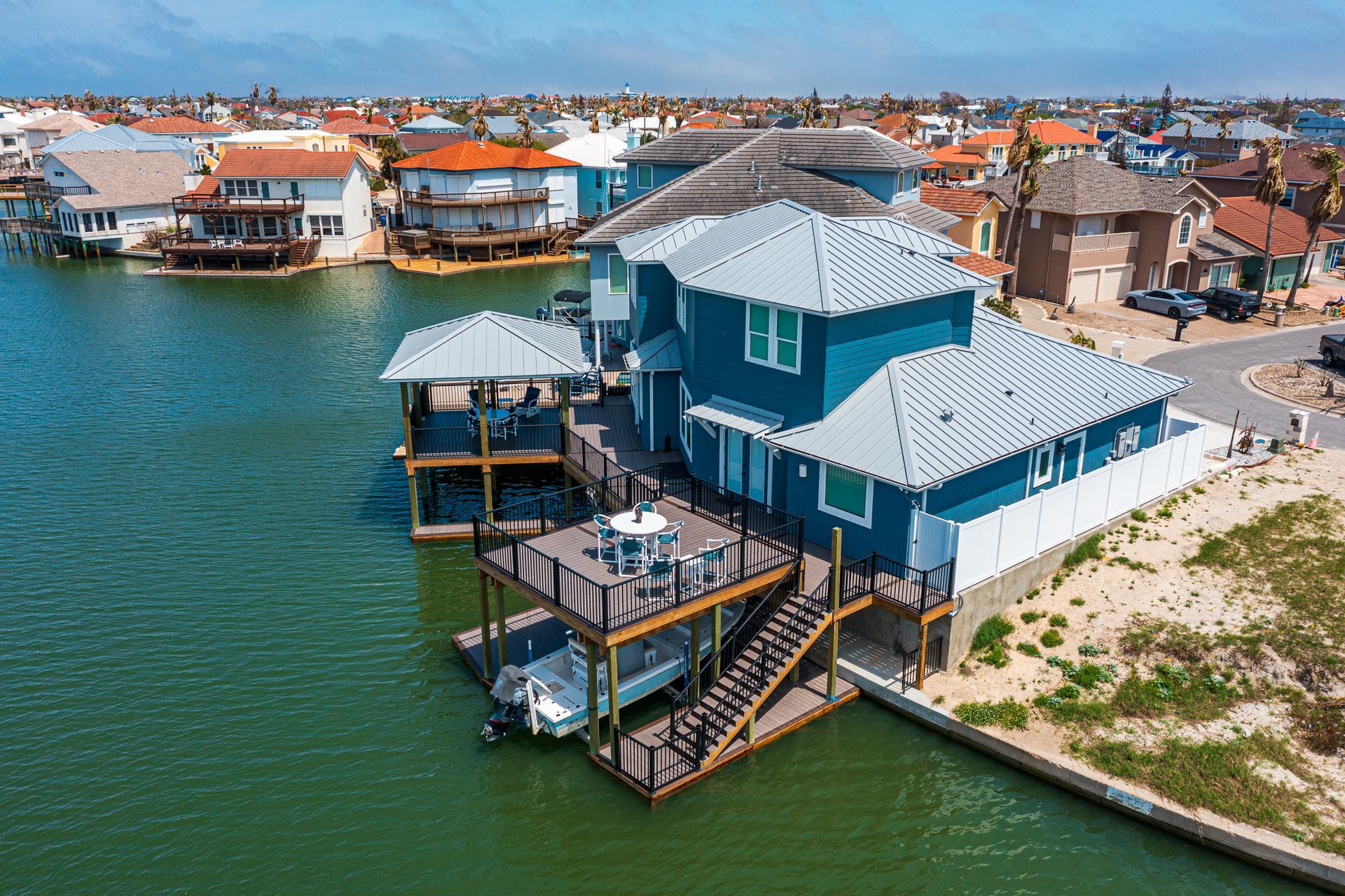 An aerial view of a house sitting on top of a body of water.