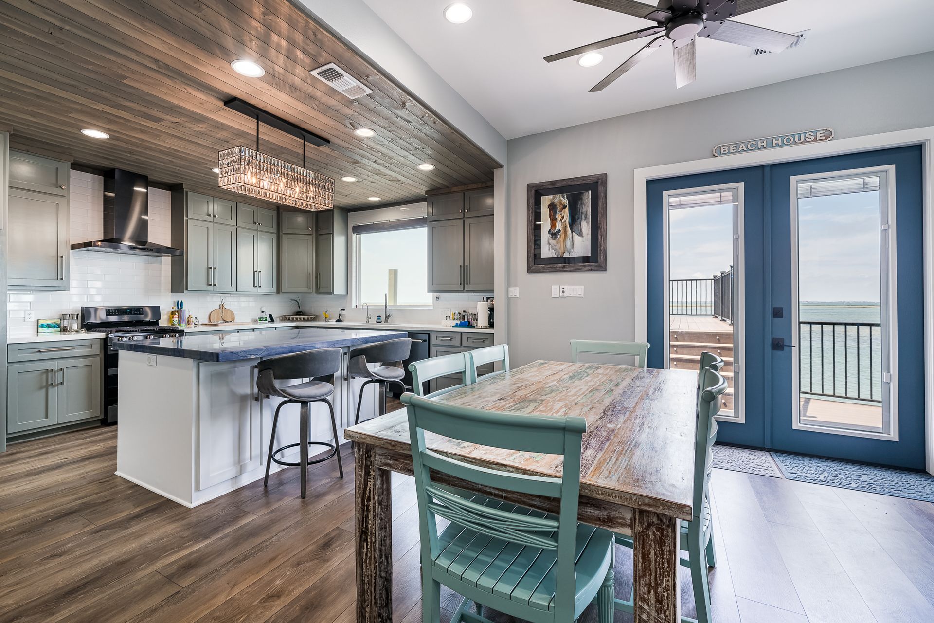 A kitchen and dining room in a house with a table and chairs