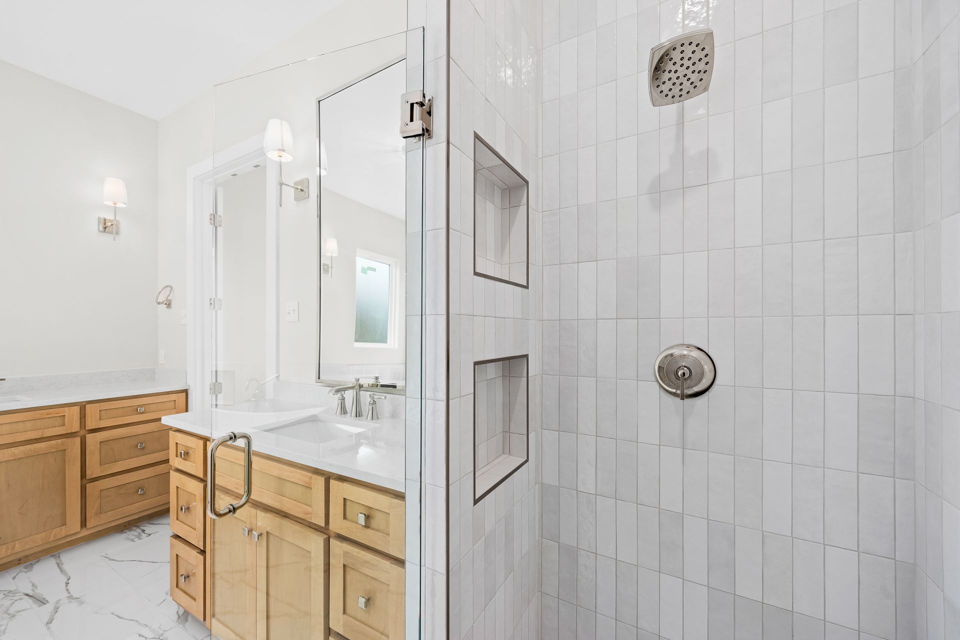 A bathroom with a walk in shower and a sink.