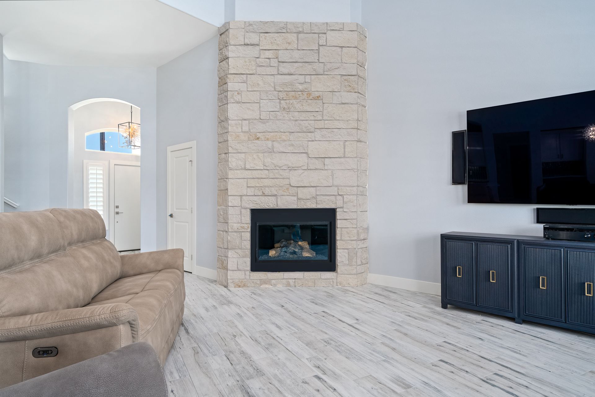 A living room with a fireplace and a flat screen tv.