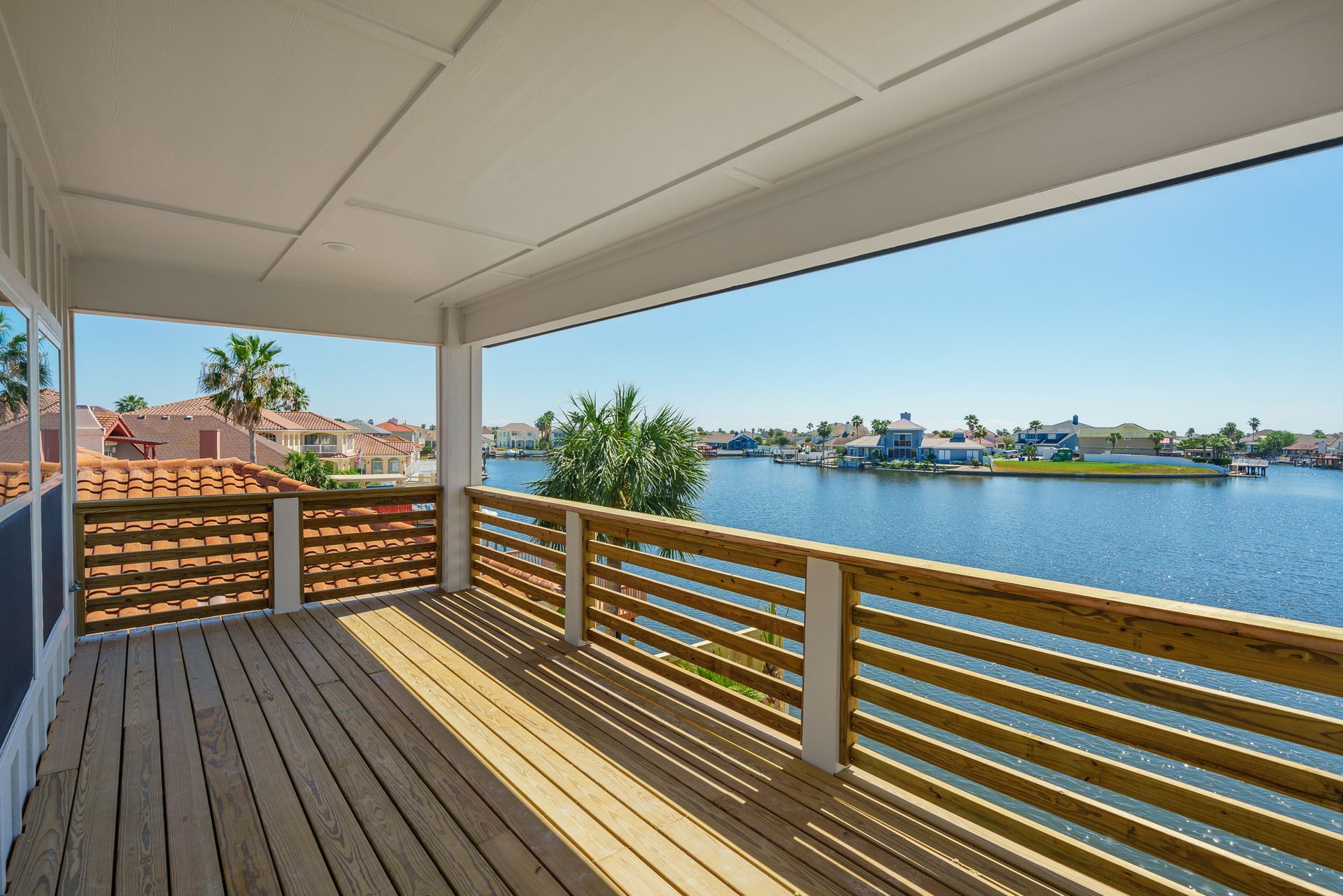 A large wooden deck overlooking a body of water