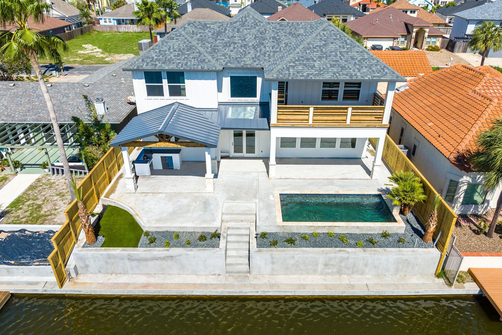 An aerial view of a house with a pool in the backyard.