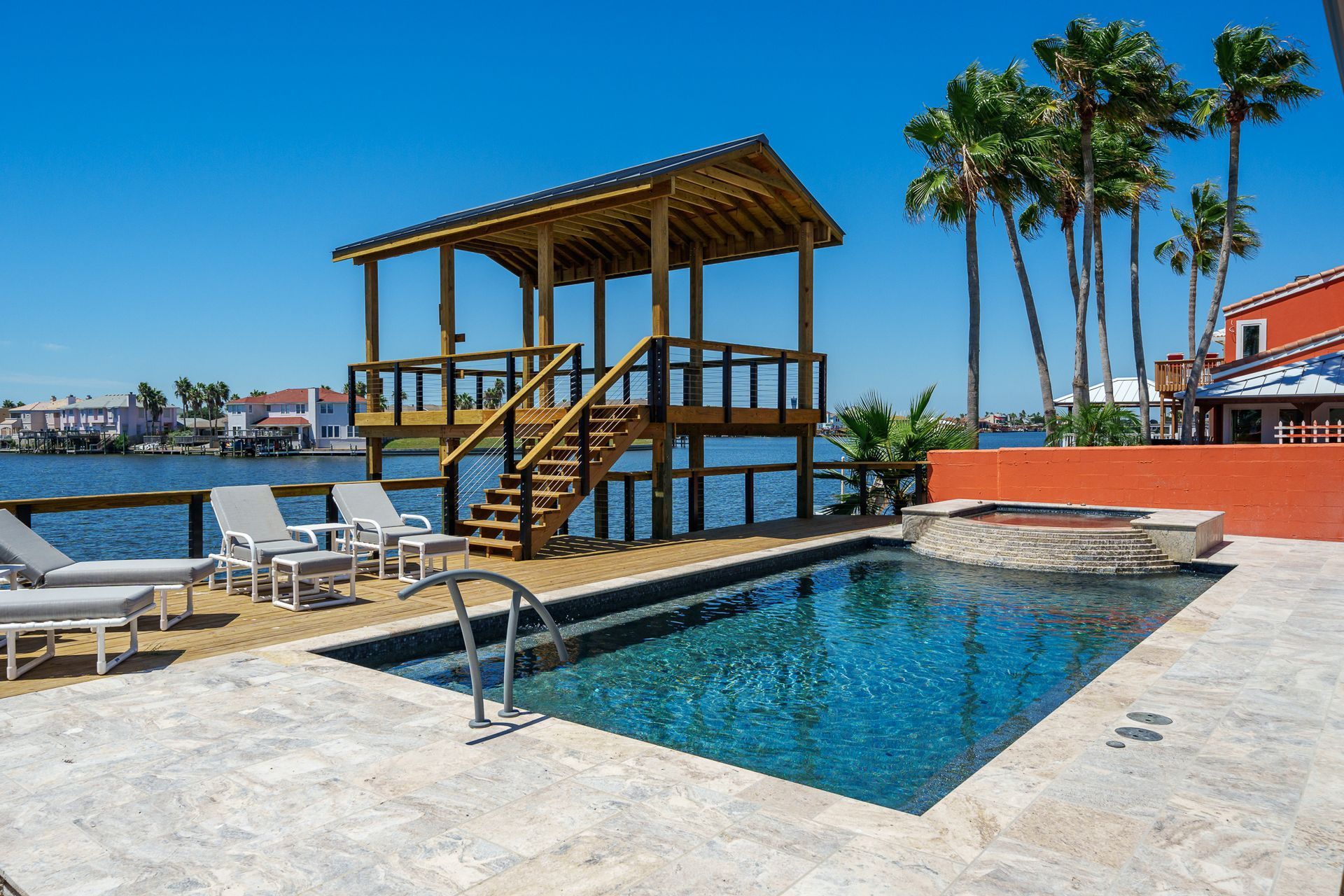 A large swimming pool with a gazebo in the background