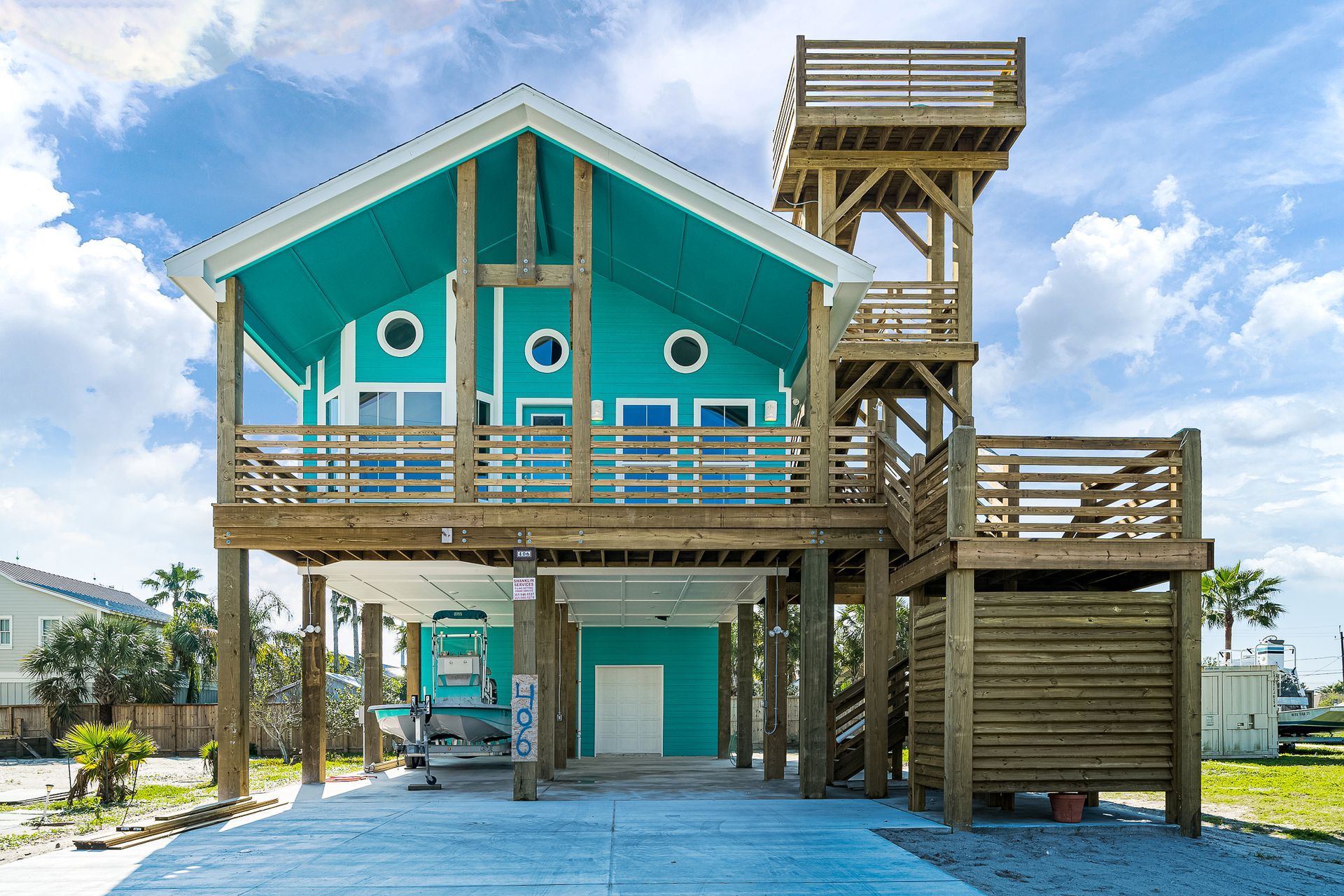 A blue house with a tower on top of it