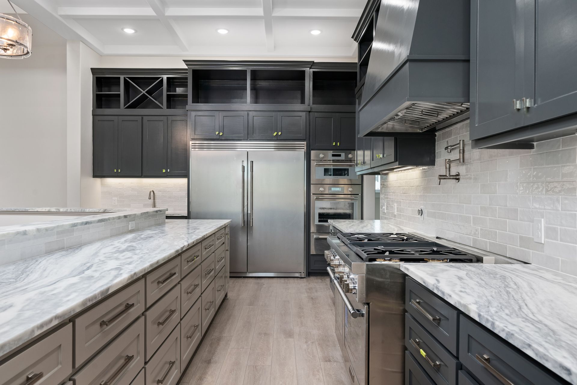 A kitchen with stainless steel appliances and granite counter tops.