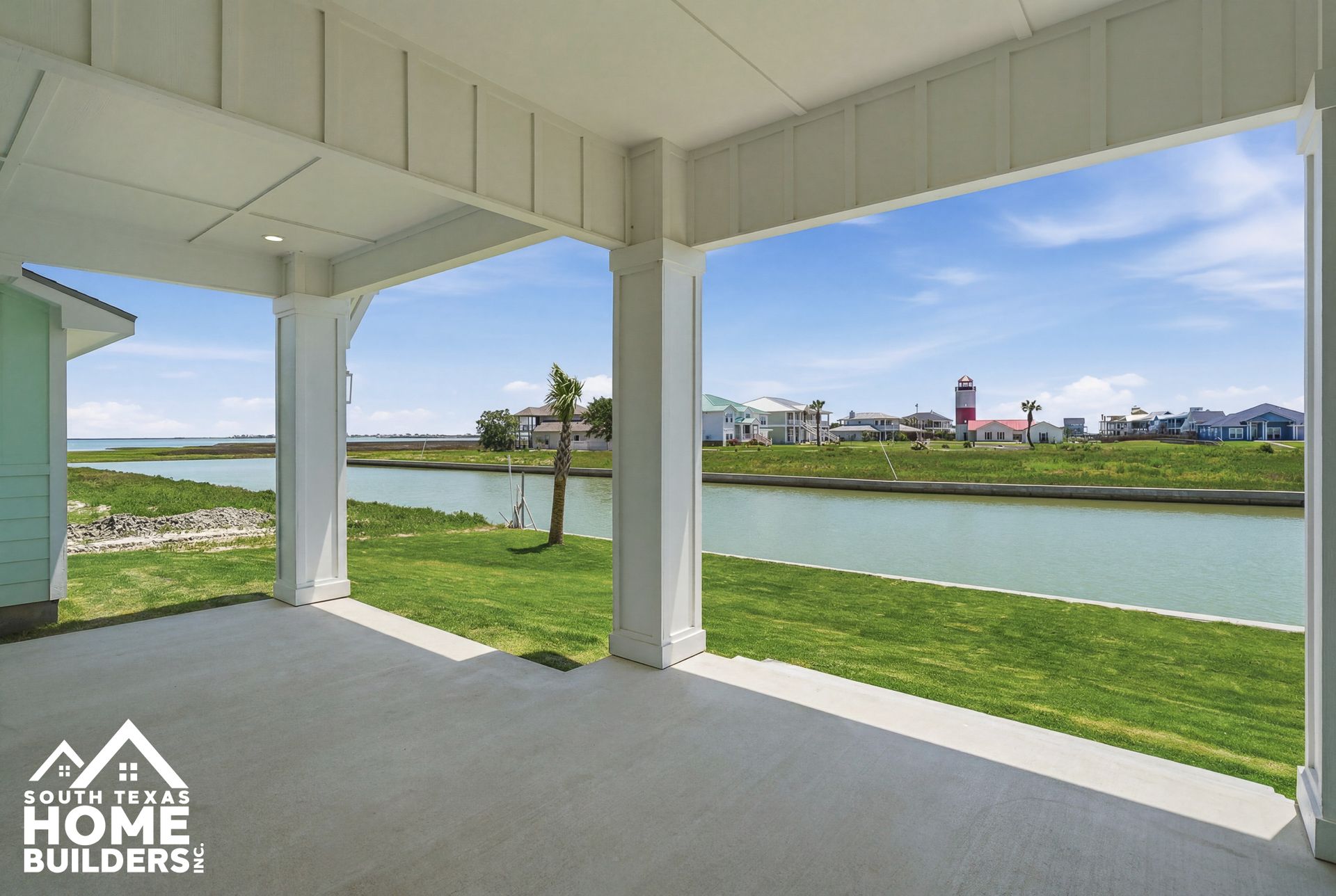 Covered patio overlooking a river and city skyline on a bright day