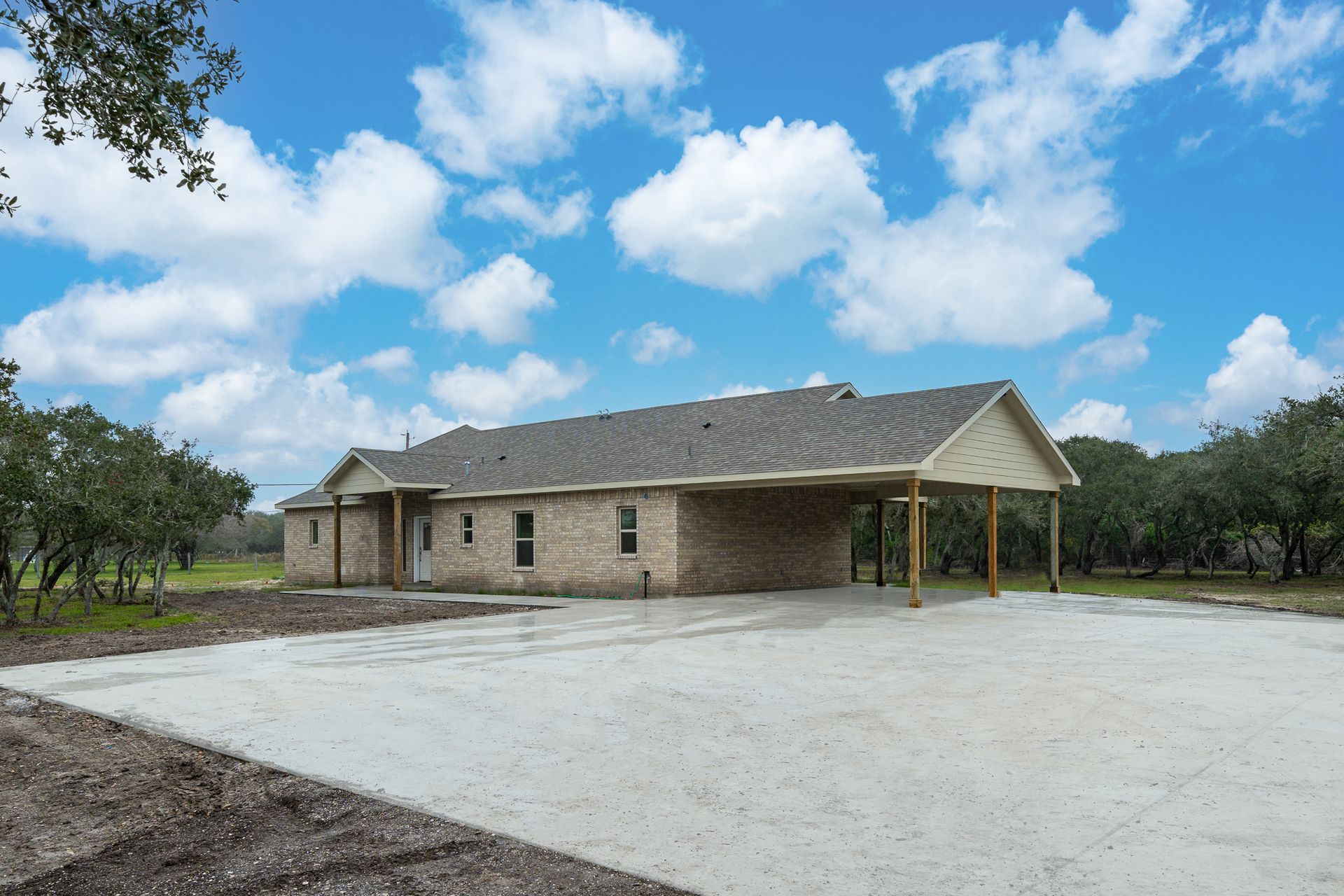 A brick house with a driveway in front of it