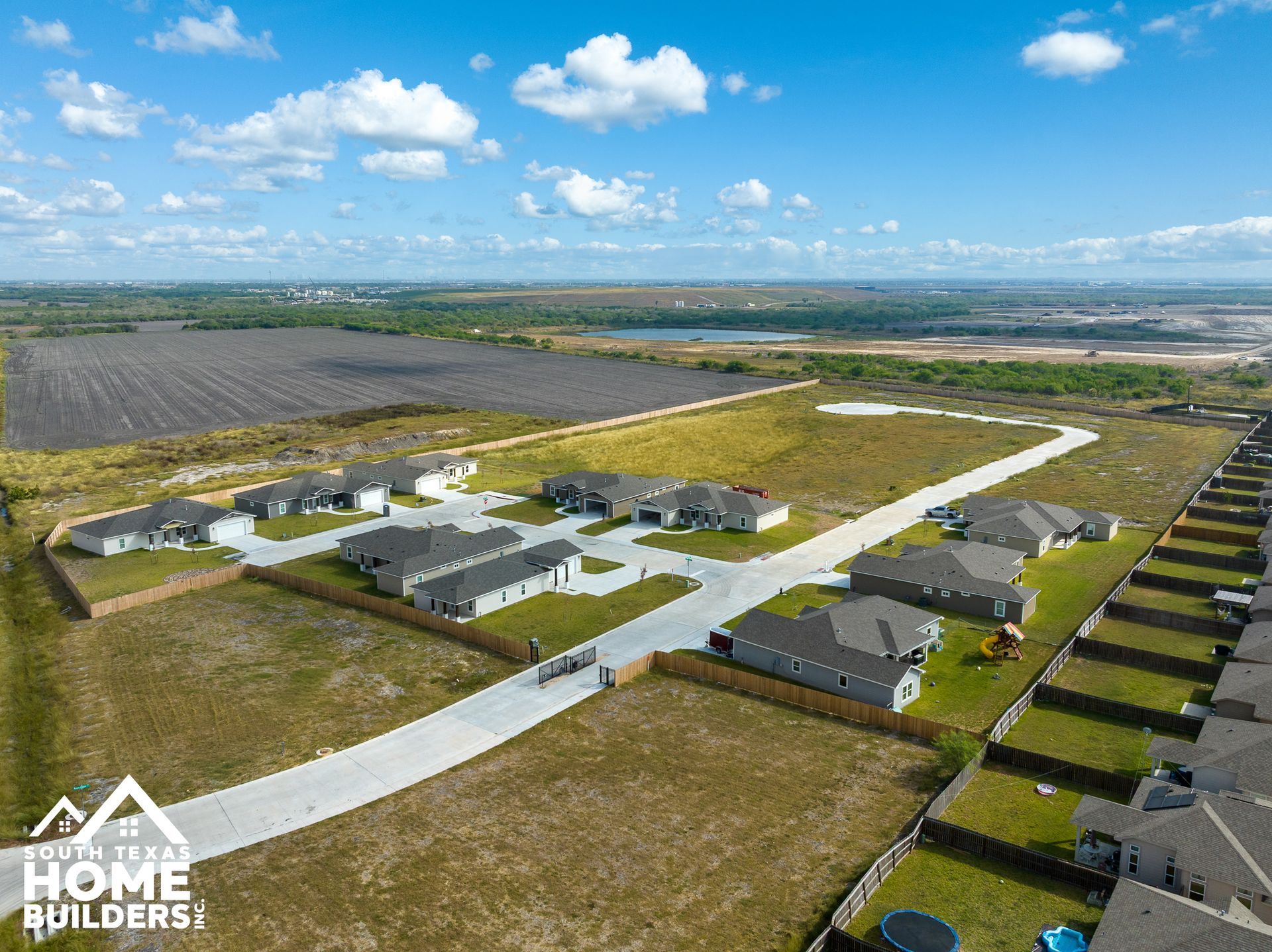 Aerial view of houses in a new housing development on a sunny day.