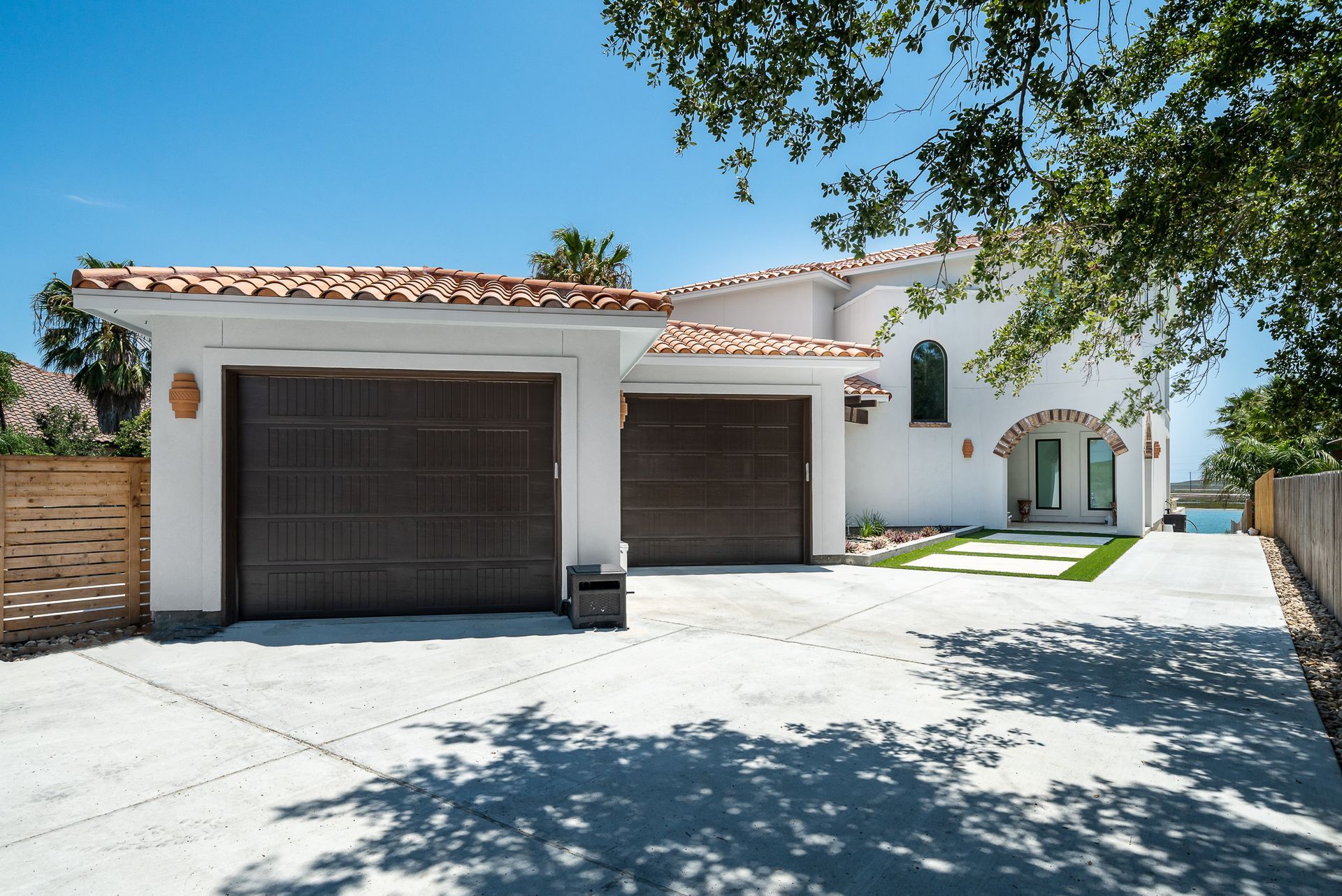 A white house with a brown garage door