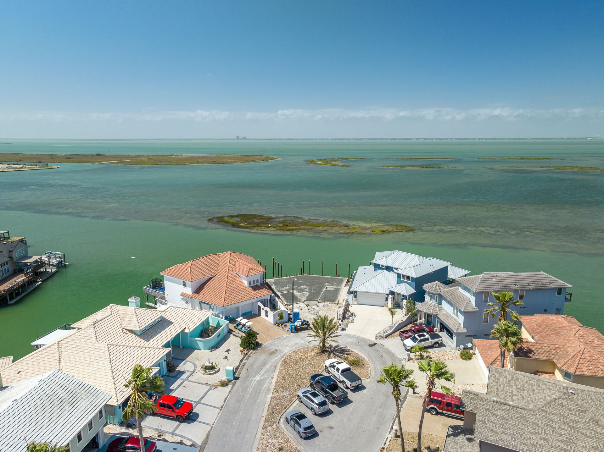 An aerial view of a small town next to a body of water.