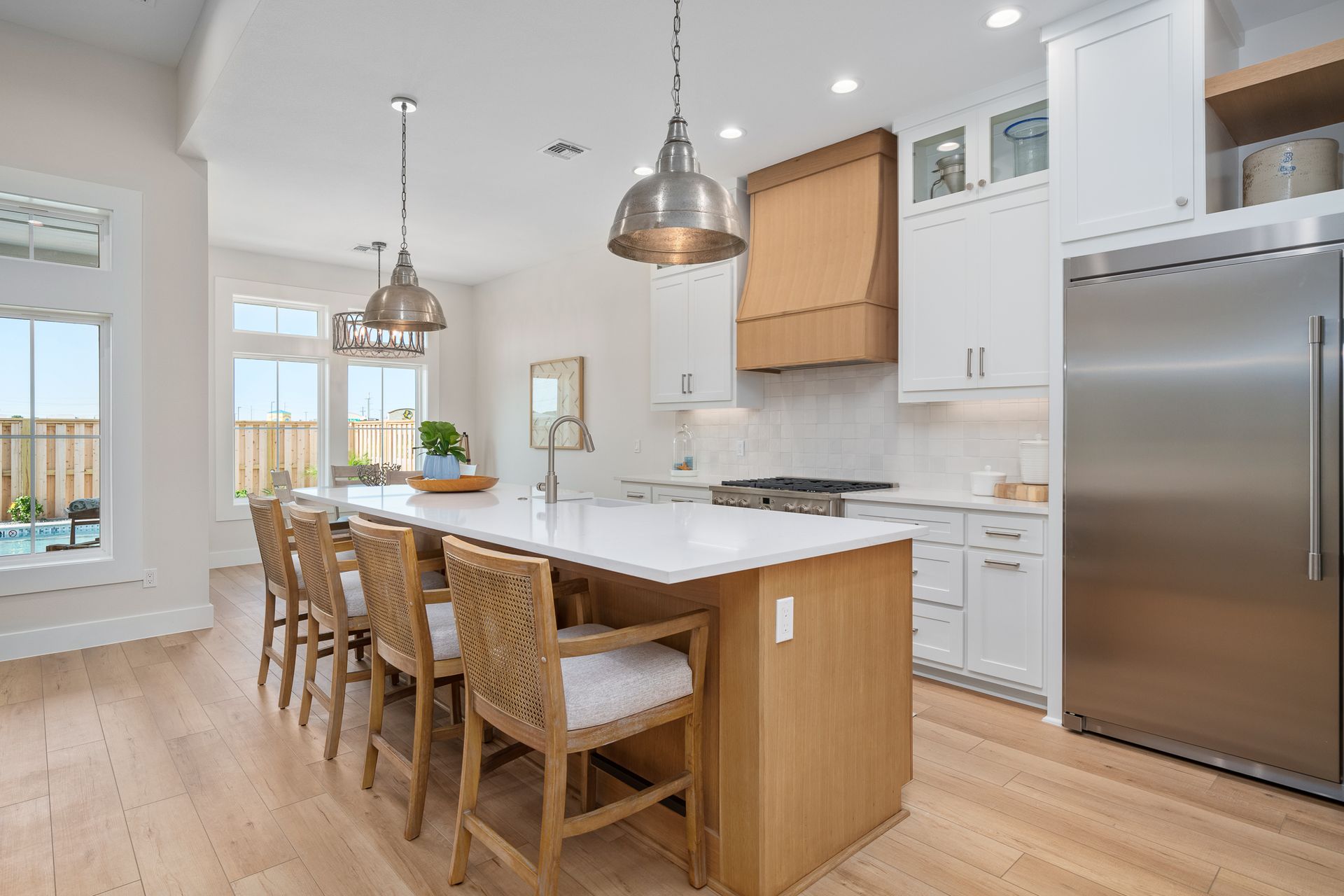 A kitchen with a large island and stainless steel appliances.