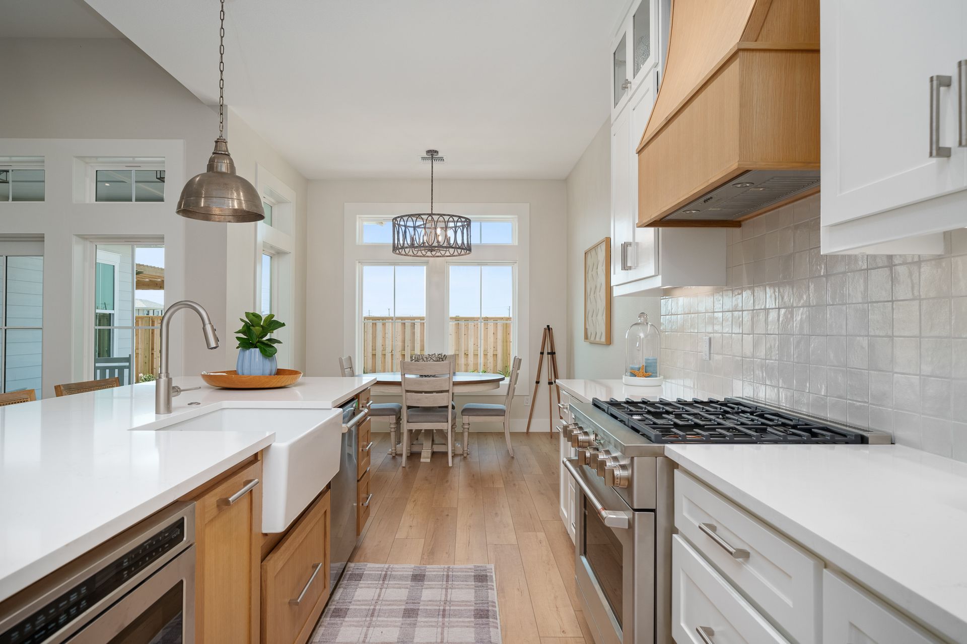 A kitchen with a stove , sink , and dishwasher.