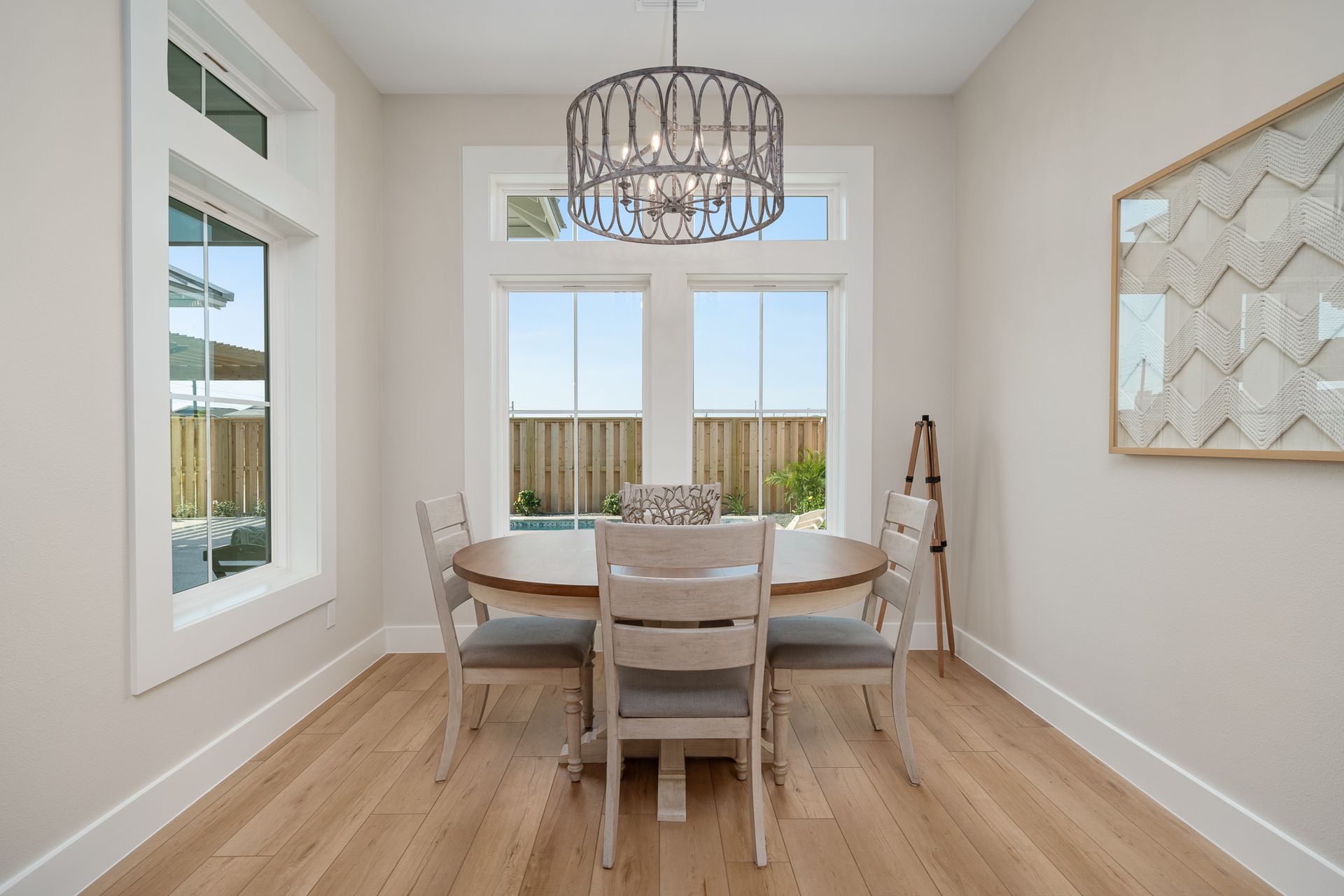 A dining room with a table and chairs and a chandelier.