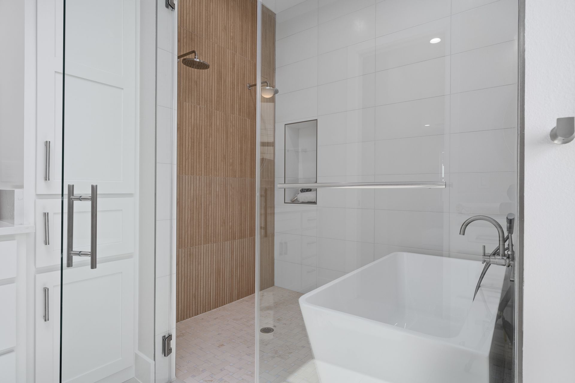 A bathroom with a bathtub and a walk in shower.