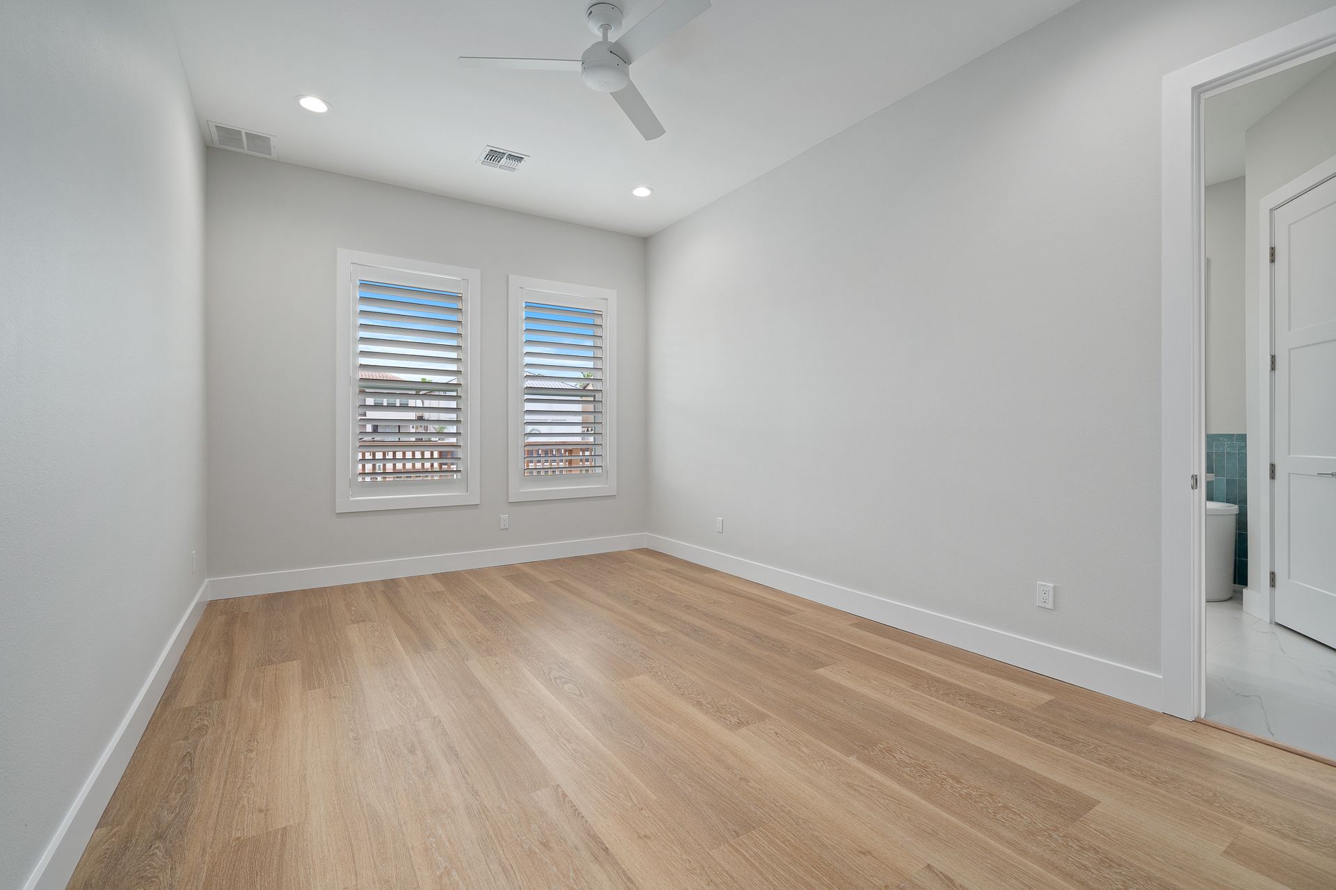 A hallway with stairs leading up to the second floor of a house.
