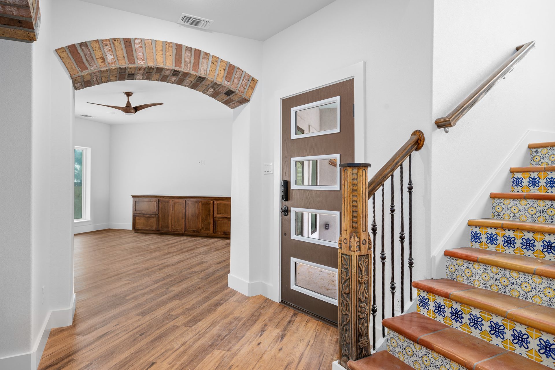 A hallway with stairs leading up to the second floor of a house.