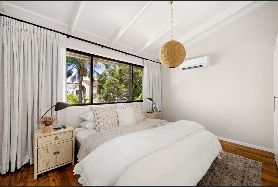 A Bedroom with A Bed, Nightstand, and Window — Artizen Curtains in Mooloolaba, QLD