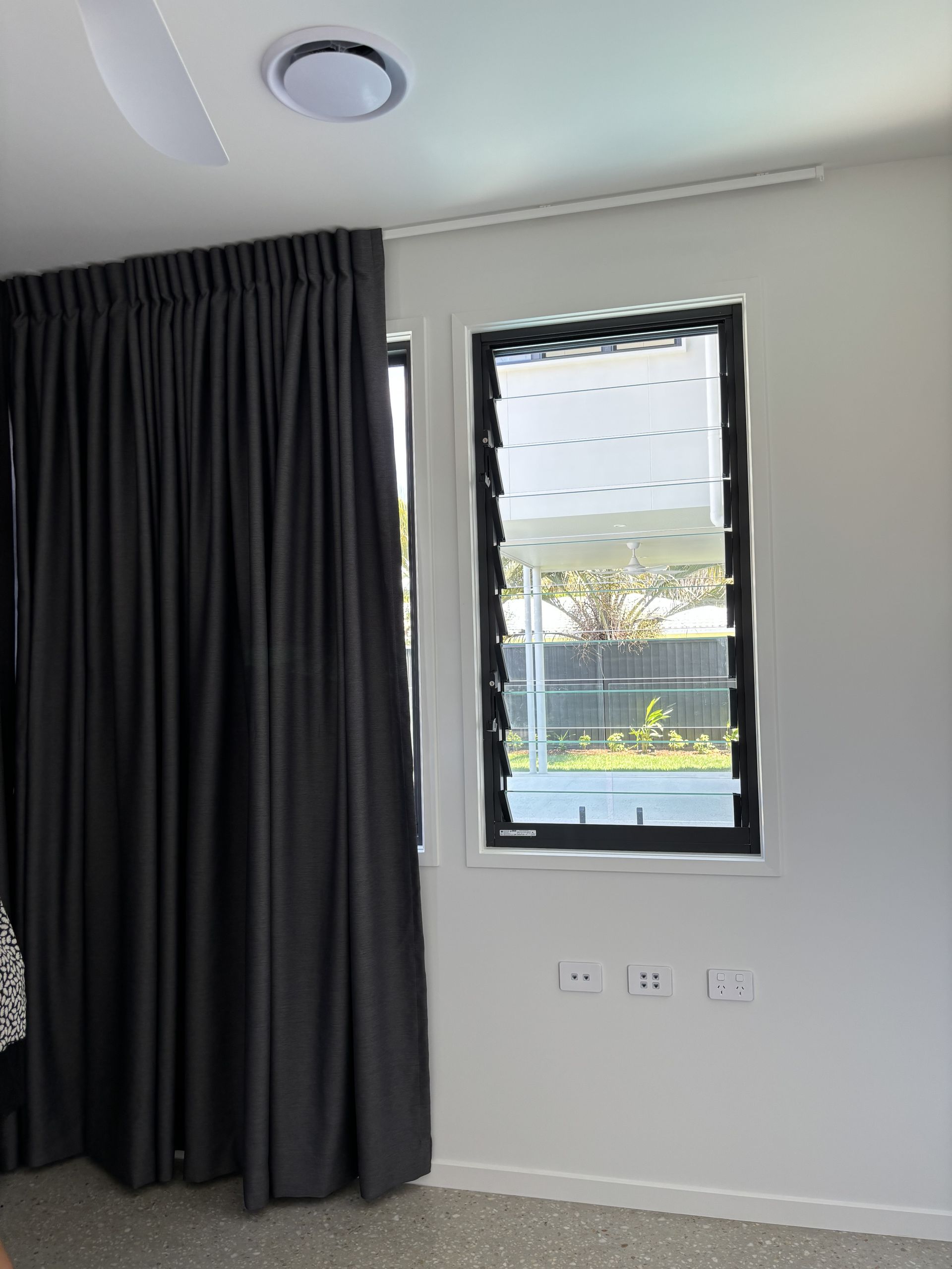 A Chair in Front of A Window with A View of The Ocean — Artizen Curtains in Mooloolaba, QLD