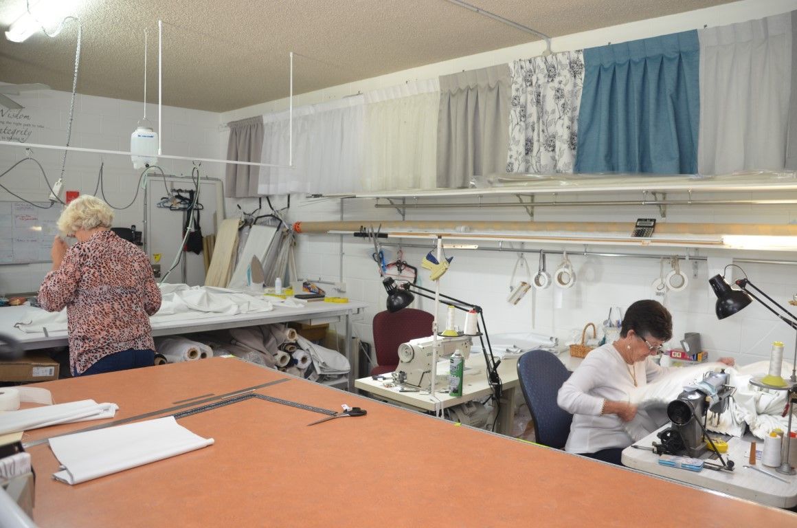 A Woman is Working on a Sewing Machine in a Workshop — Artizen Curtains in Mooloolaba, QLD