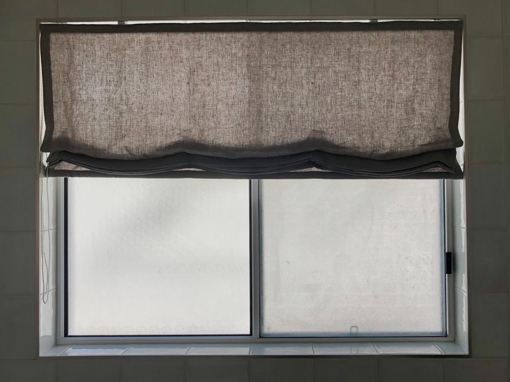 A Window With a Blind on It and a Sliding Glass Door — Artizen Curtains in Mooloolaba, QLD