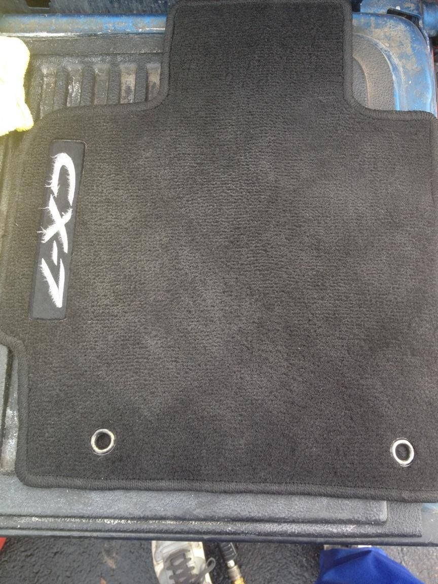 Clean vehicle carpet with Showcase Ceramic Coating Solutions floor mat
