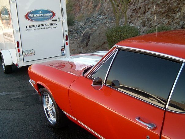 Classic Chevrolet with polished paint parked beside Showcase Ceramic Coating Solutions trailer