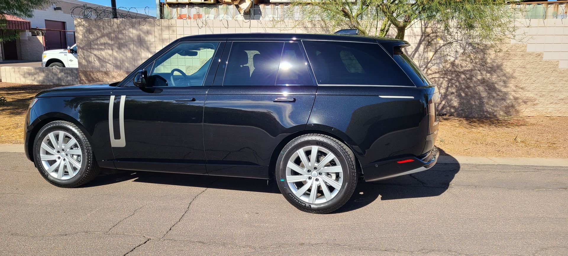 Glossy black vehicle after ceramic coating in Gilbert AZ