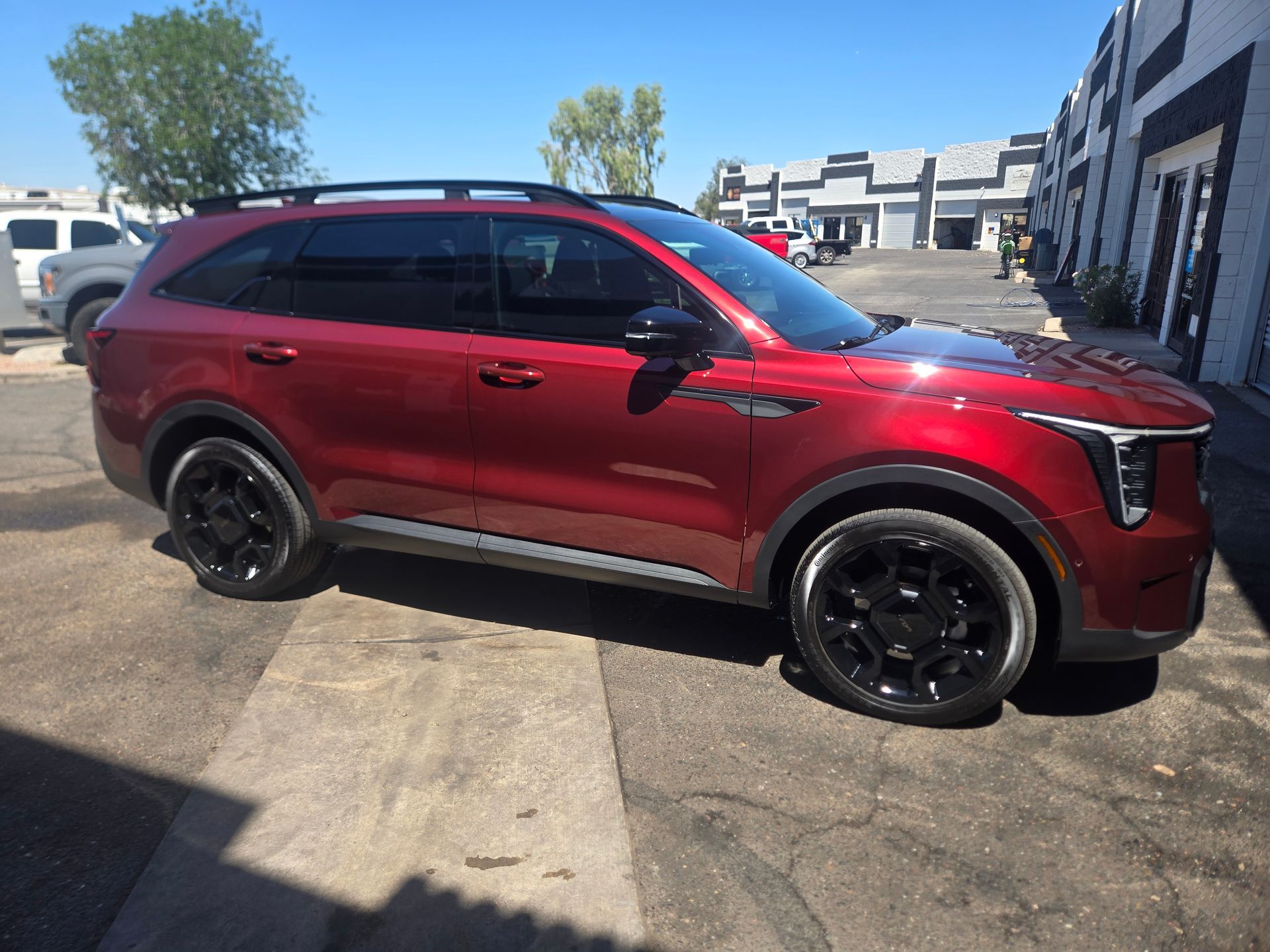 Red SUV with enhanced paint gloss after ceramic coating and exterior detailing service