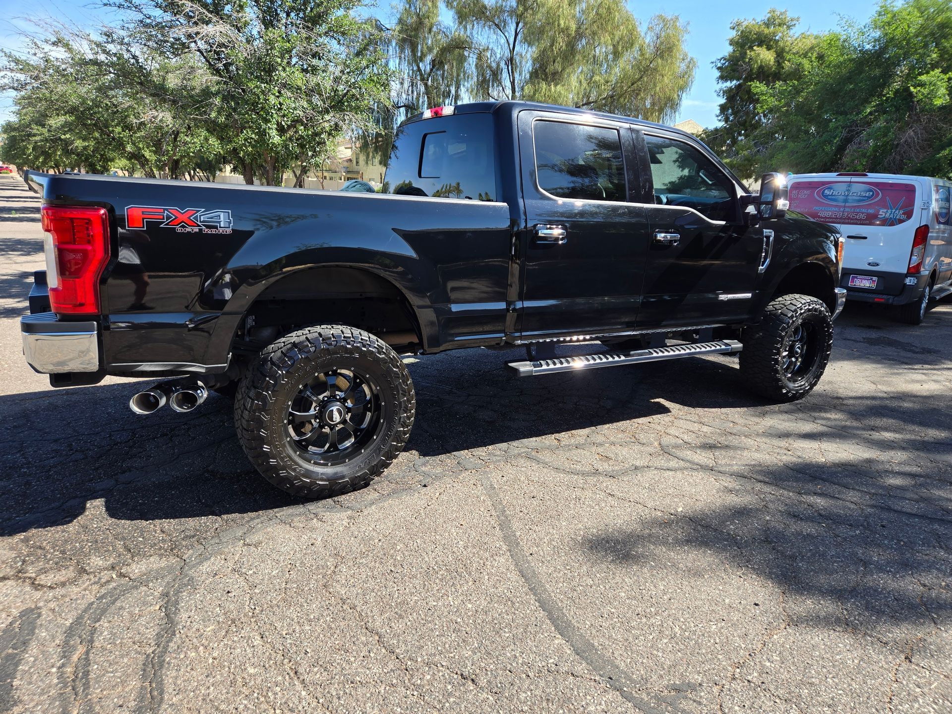 Black Ford pickup truck with polished exterior after ceramic coating service in Gilbert AZ