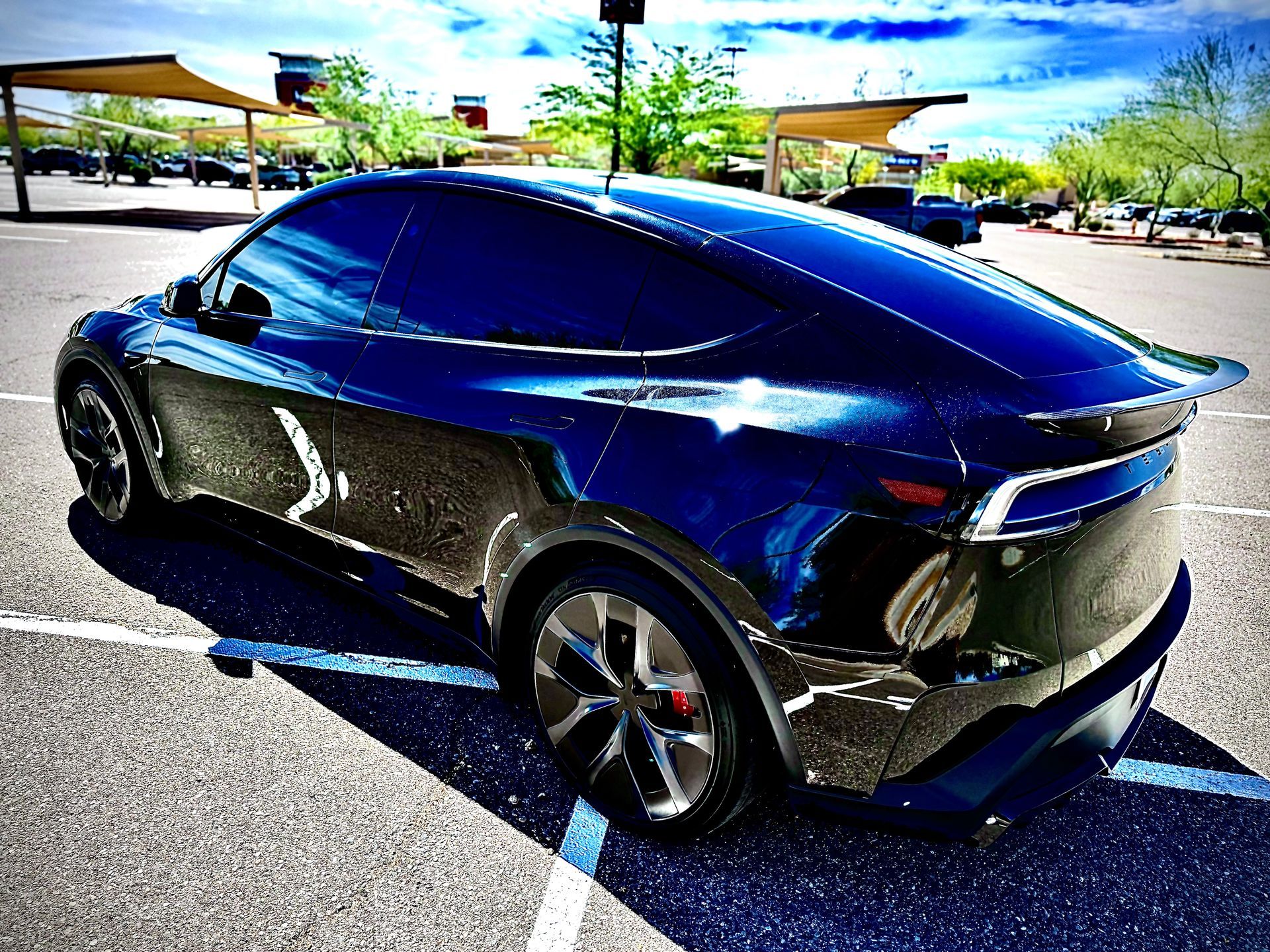 Blue SUV with glossy ceramic coating finish reflecting sunlight after professional detailing