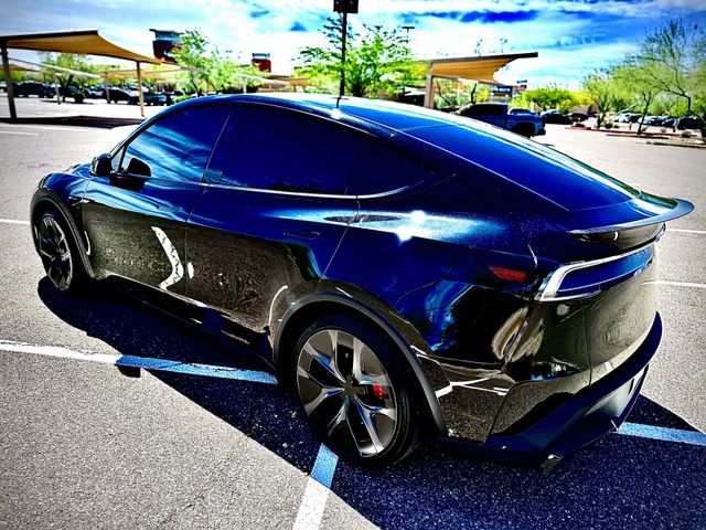 Blue SUV with glossy ceramic coating finish reflecting sunlight after professional detailing