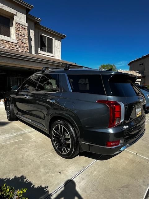 Dark gray Cadillac Escalade with enhanced shine after ceramic coating service