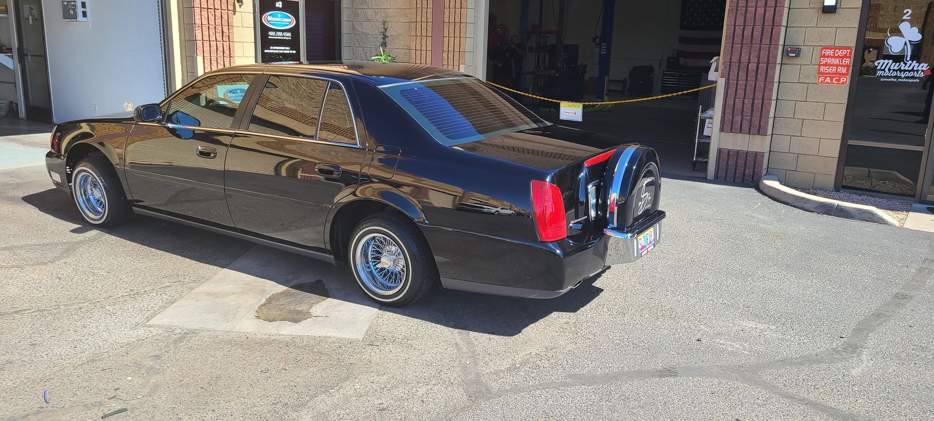 Glossy black vehicle after ceramic coating in Gilbert AZ (Matches the client's example.)