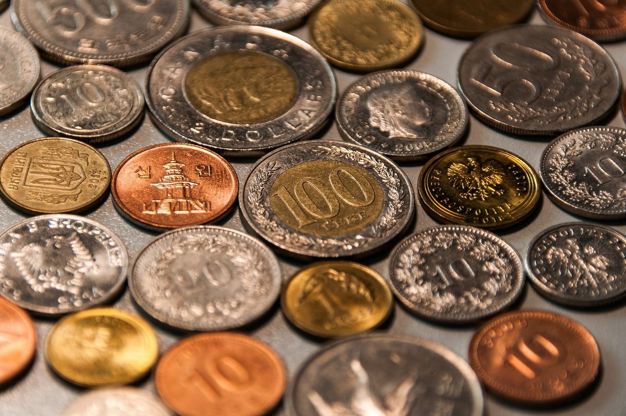 A bunch of coins on a table with one that says 100 on it