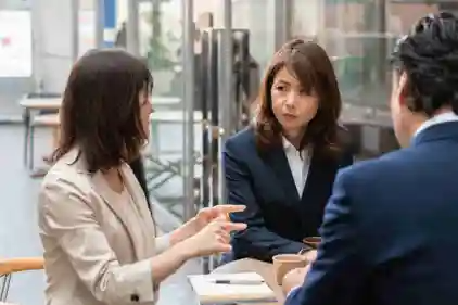 A group of people are sitting at a table having a conversation.