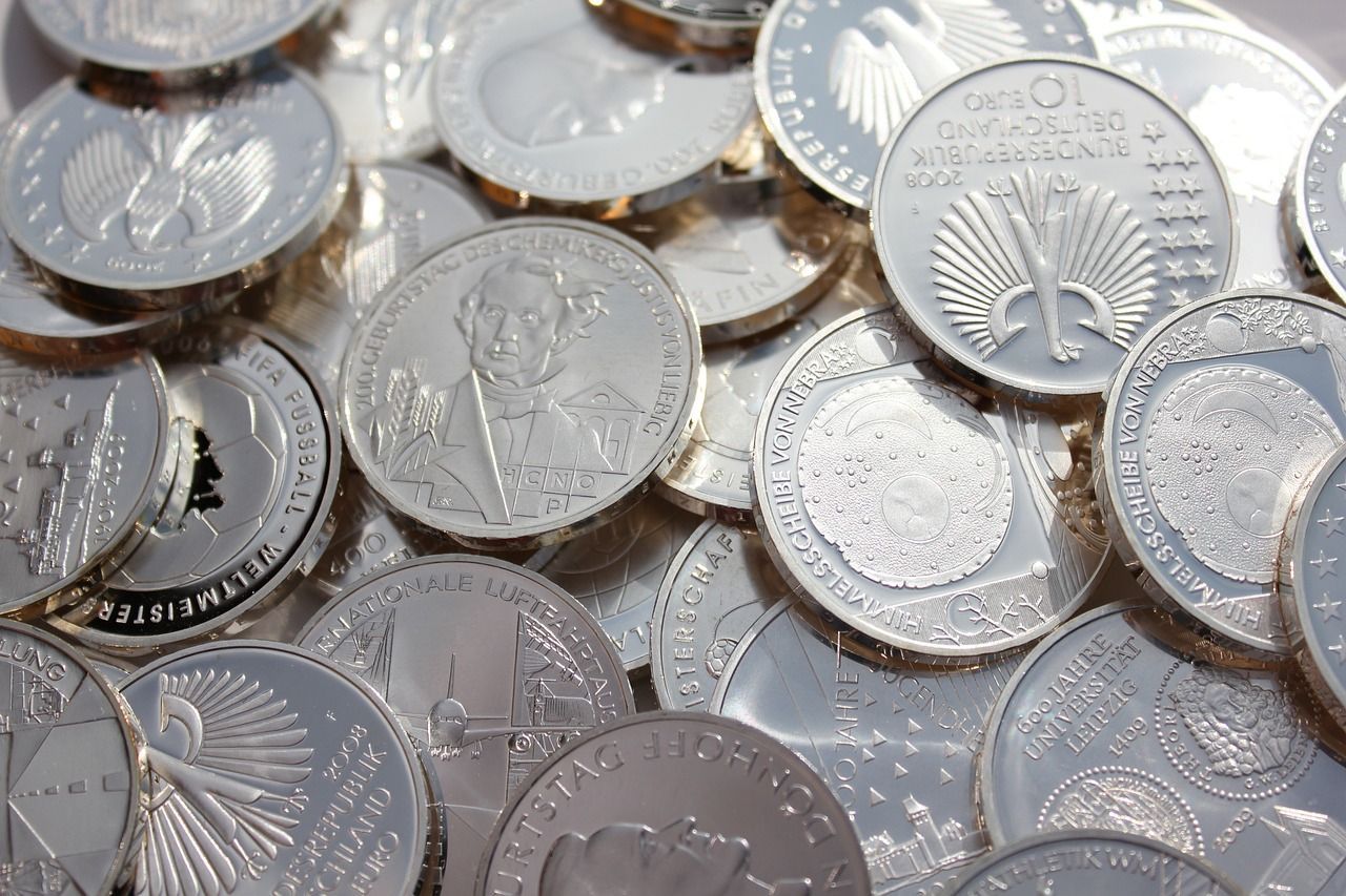 A pile of silver coins are stacked on top of each other