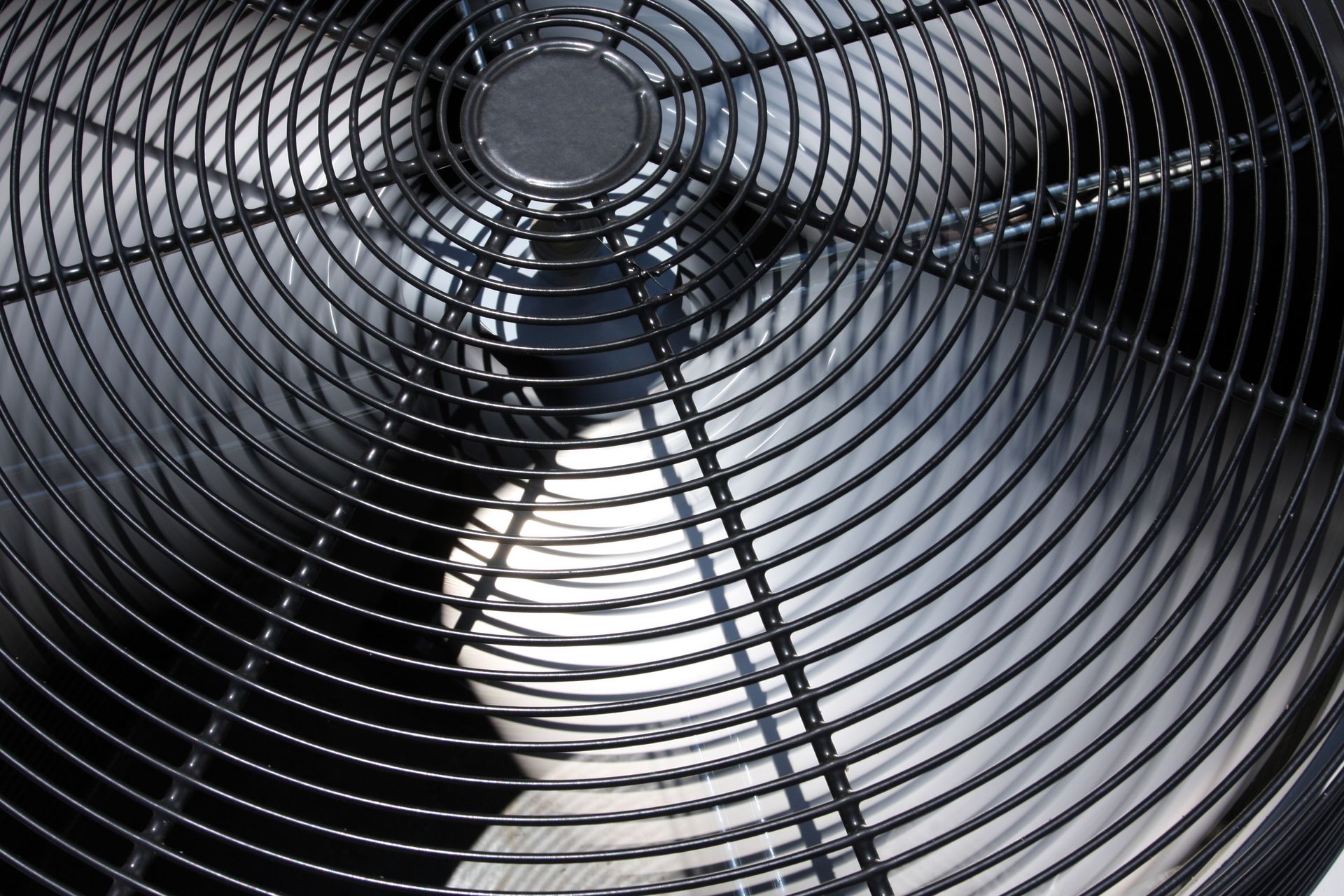 A close up of a fan with a metal cage around it