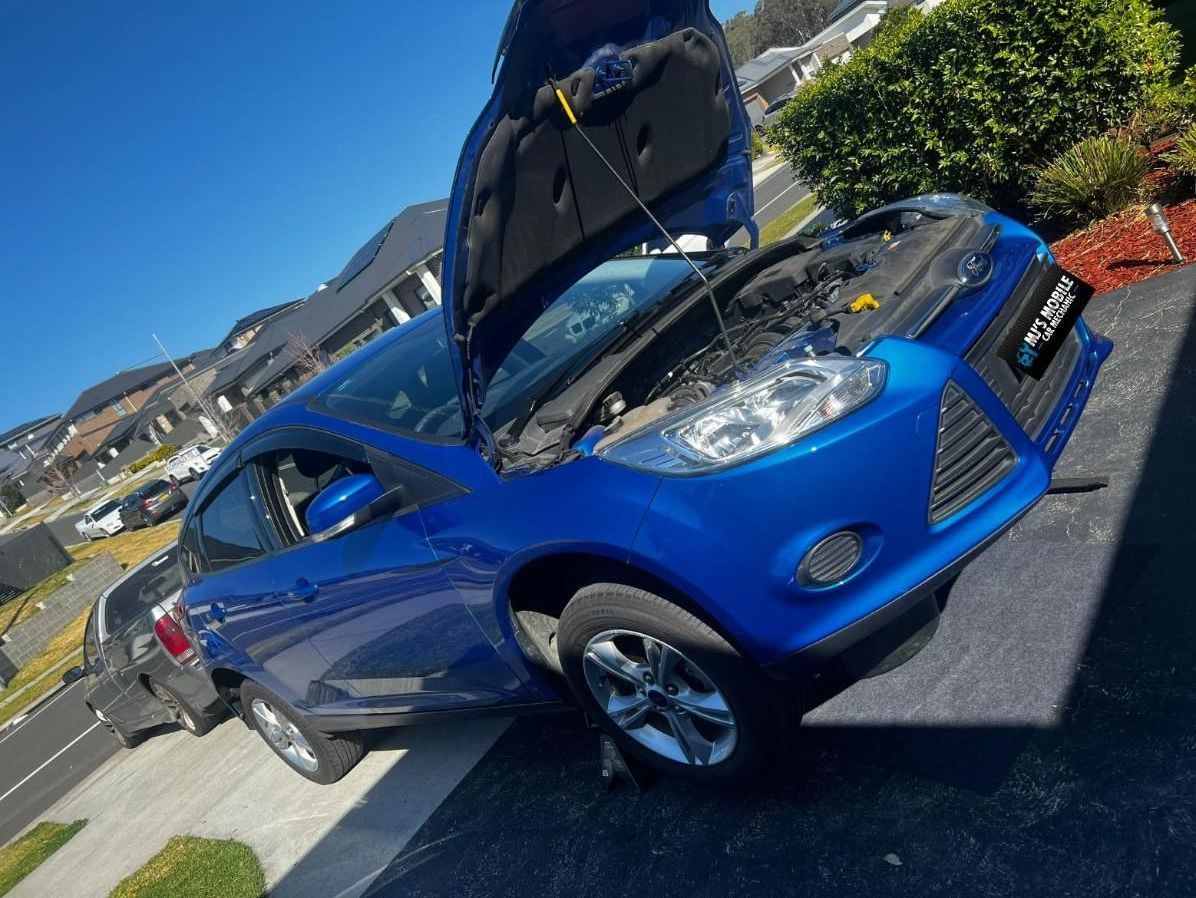 A Blue Car With The Hood Open Is Parked On The Side Of The Road — MJ's Mobile Car Mechanic In Cordeaux Heights, NSW