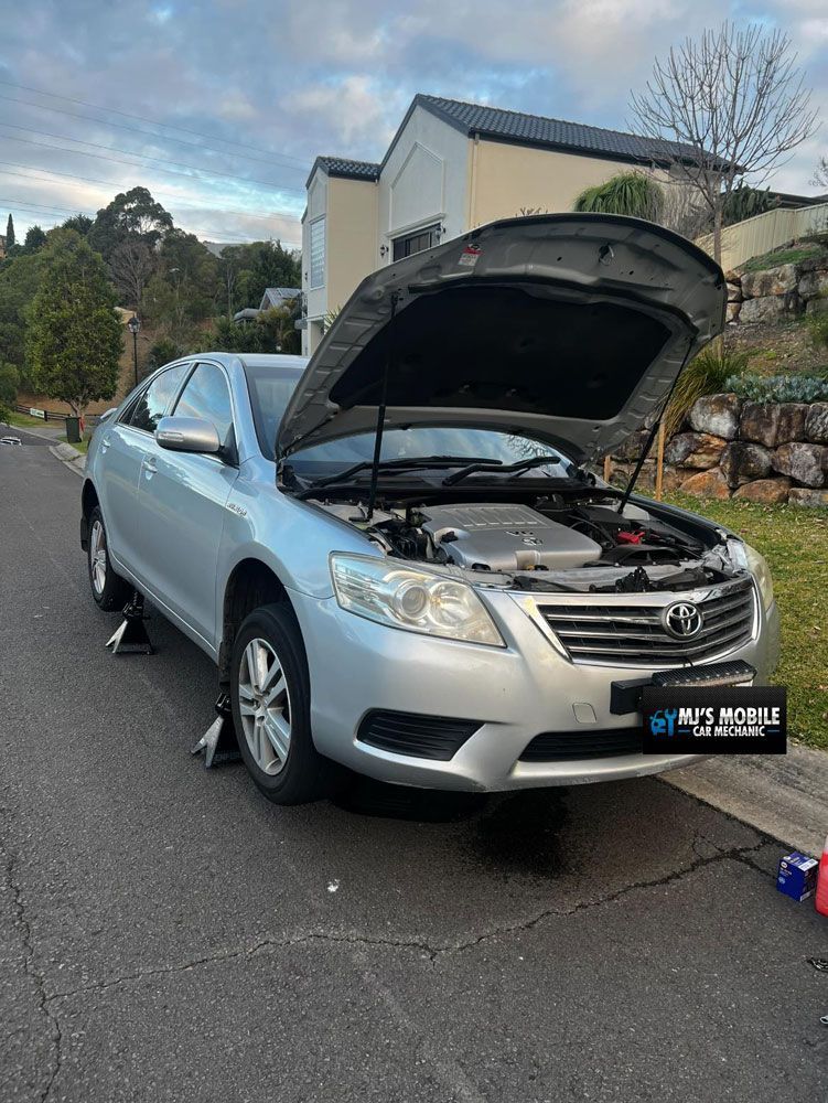 A Silver Car With The Hood Up Is Parked On The Side Of The Road — MJ's Mobile Car Mechanic In Wollongong, NSW