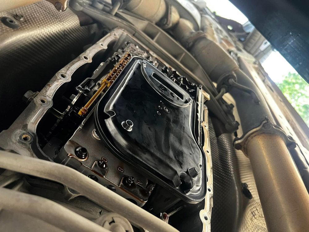 A Close Up Of A Car Engine With The Oil Pan Removed — MJ's Mobile Car Mechanic In Wollongong, NSW