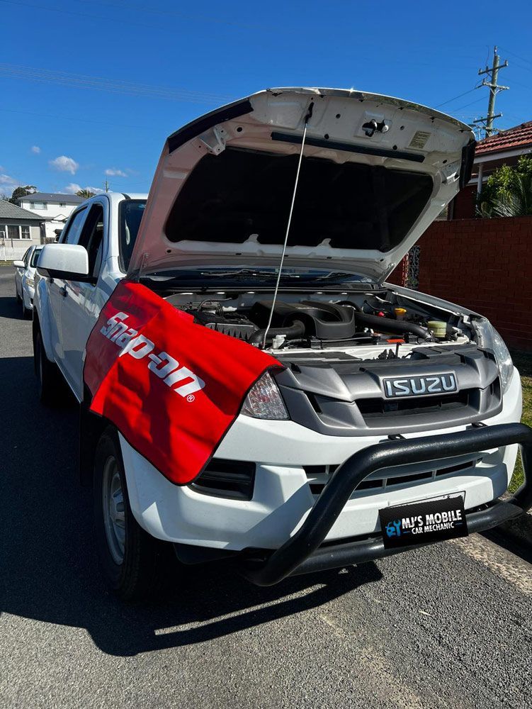 A White Truck With The Hood Up And A Red Flag On The Hood — MJ's Mobile Car Mechanic In Wollongong, NSW