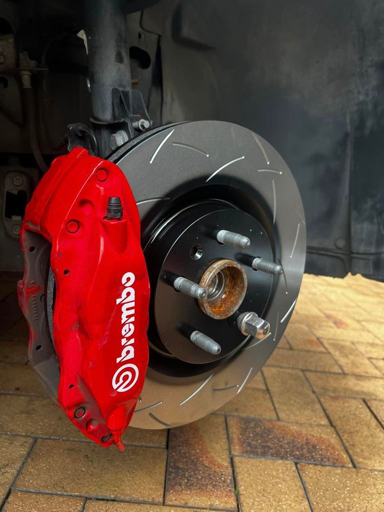 A Close Up Of A Brake Caliper On A Car — MJ's Mobile Car Mechanic In Wollongong, NSW