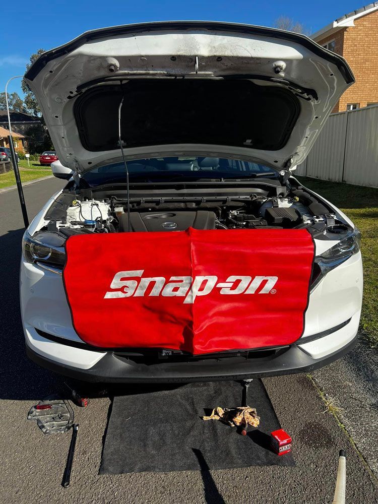 A White Car With The Hood Up And A Snap On Cover On The Front — MJ's Mobile Car Mechanic In Wollongong, NSW