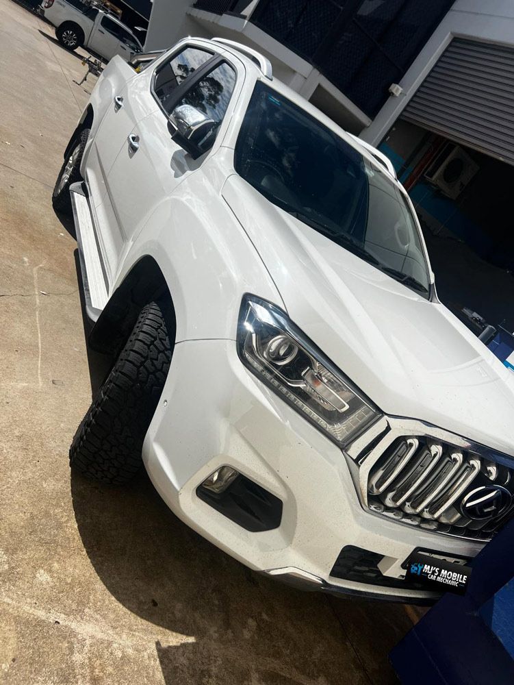 A White Truck Is Parked In A Parking Lot — MJ's Mobile Car Mechanic In Wollongong, NSW
