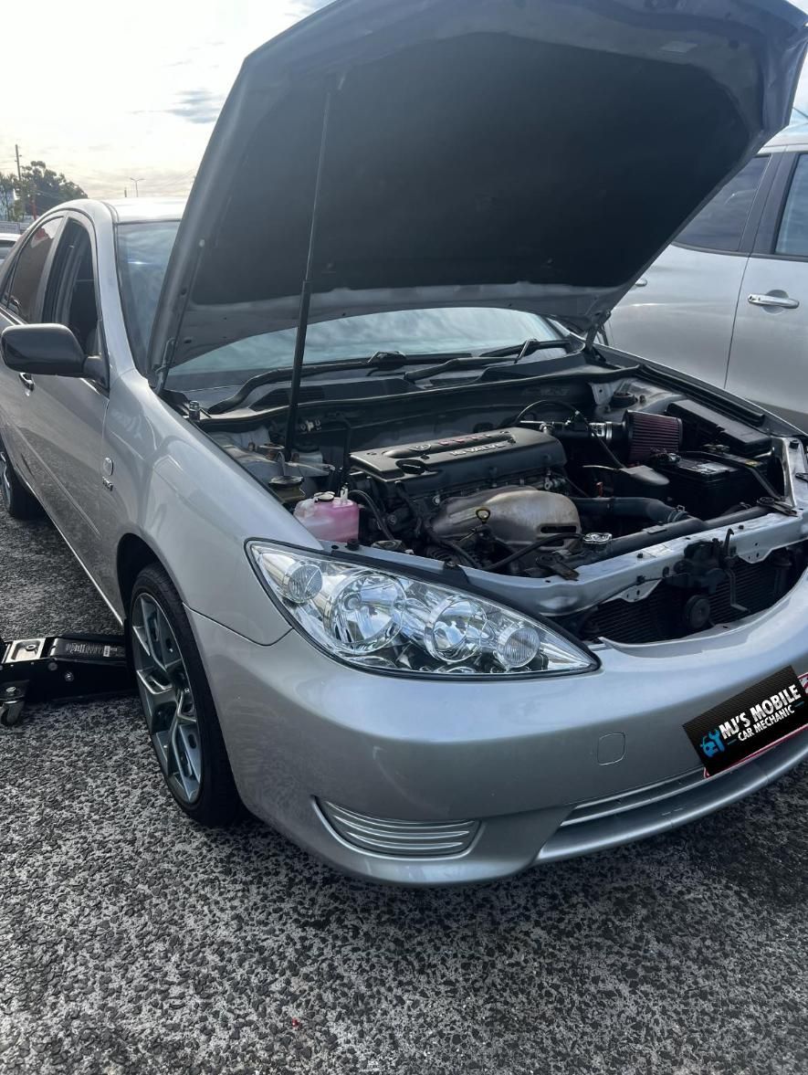A Silver Car With The Hood Open Is Parked On A Gravel Road — MJ's Mobile Car Mechanic In Unanderra, NSW