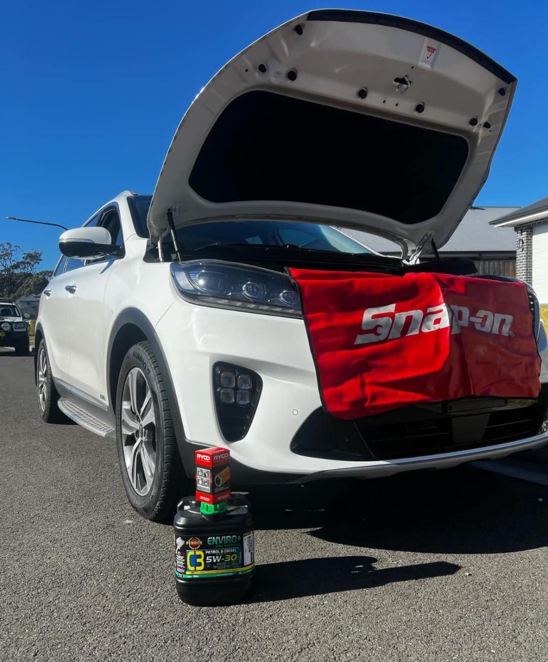 A White Car With The Hood Up And A Snap On Towel On The Front — MJ's Mobile Car Mechanic In Fairy Meadow, NSW