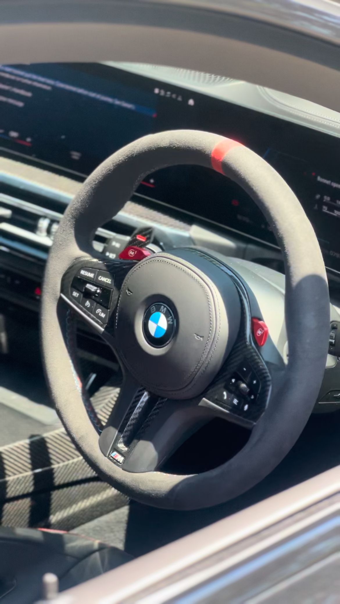 BMW steering wheel, gray suede with red accent, in car interior — MJ's Mobile Car Mechanic In Austinmer, NSW