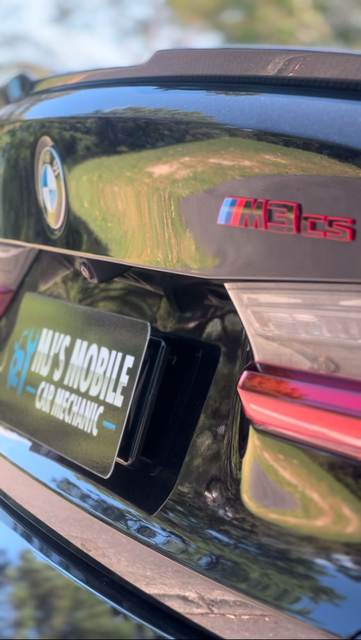 Close-Up of A Glossy Black Bmw M5 Badge — MJ's Mobile Car Mechanic In Kiama, NSW