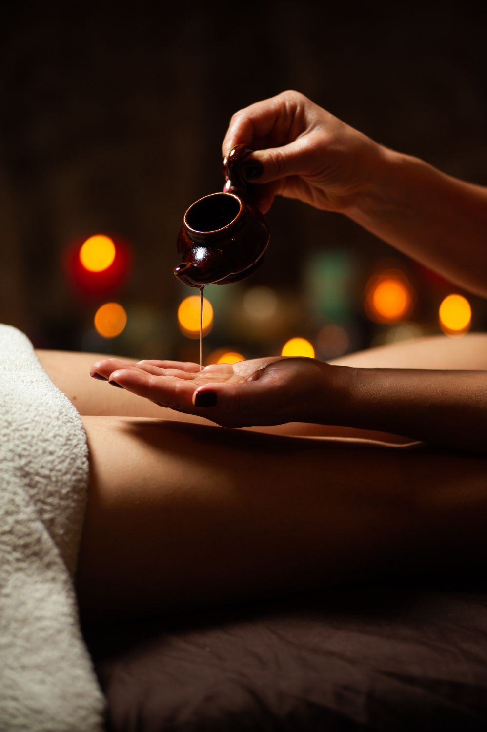 Una mujer está recibiendo un masaje con aceite en un spa.